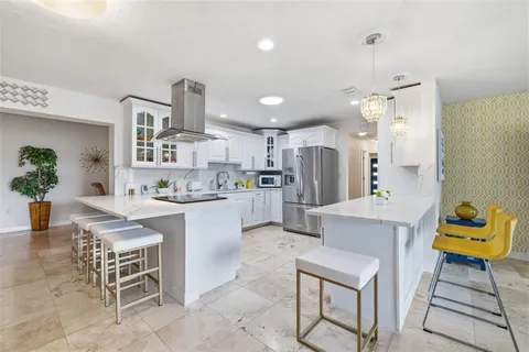 a kitchen with refrigerator and cabinets