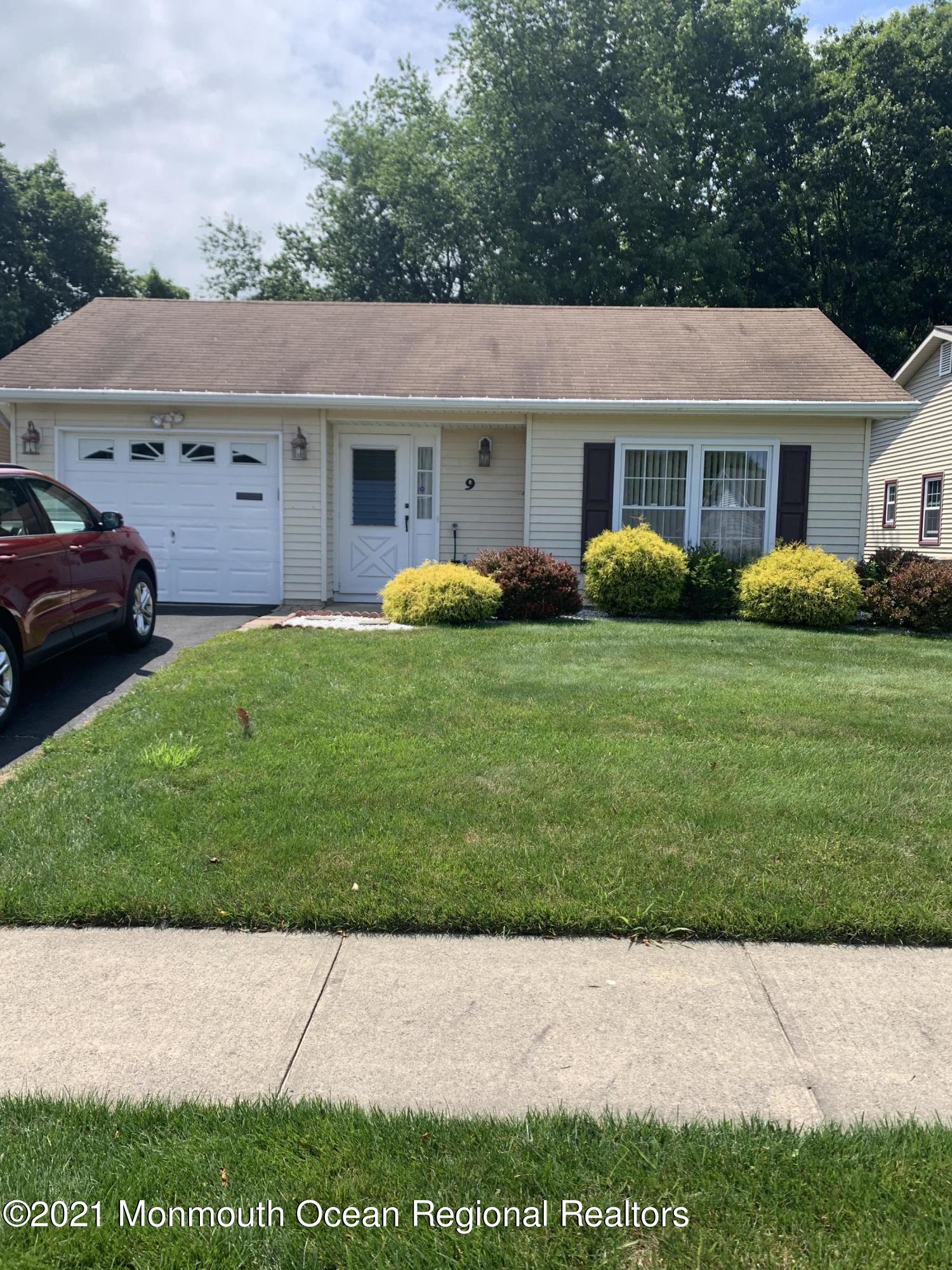 9 Olympus Way Brick, NJ 08724 - Photo 1 of 2 a front view of a house with a garden
