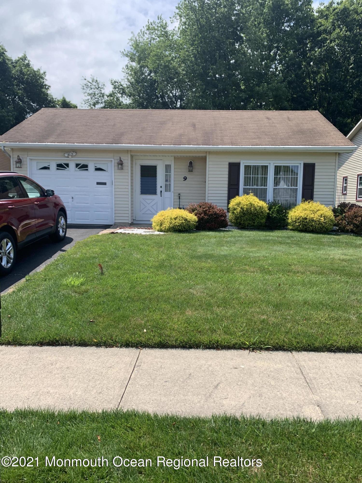 9 Olympus Way Brick, NJ 08724 - Photo 2 of 2 a view of a white house with a yard plants and large tree