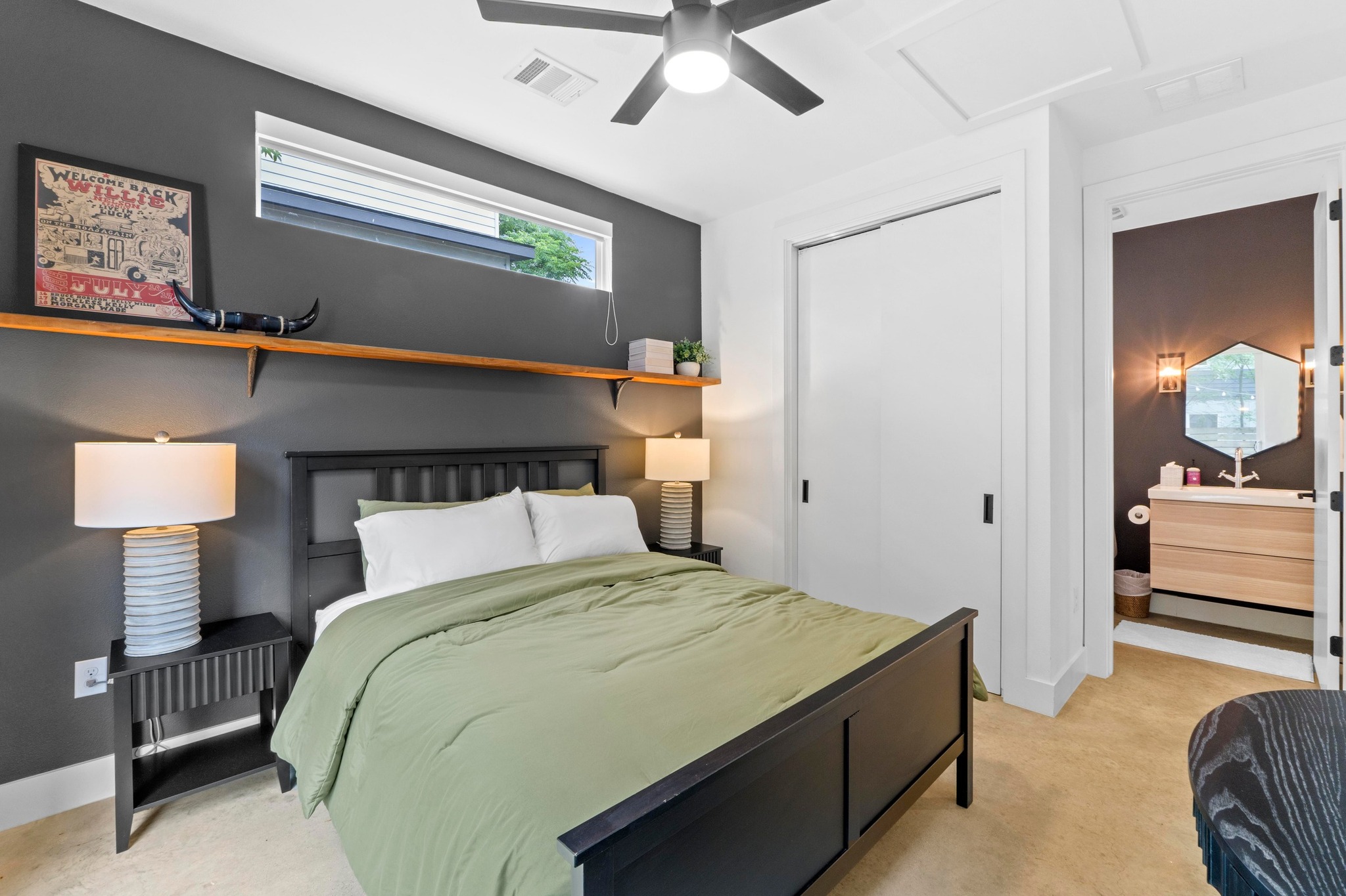 1706 Perez Street, Unit 2 Austin, TX 78721 - Photo 15 of 29 Well-appointed bedroom featuring a deep accent wall and convenient access to an en-suite bath.