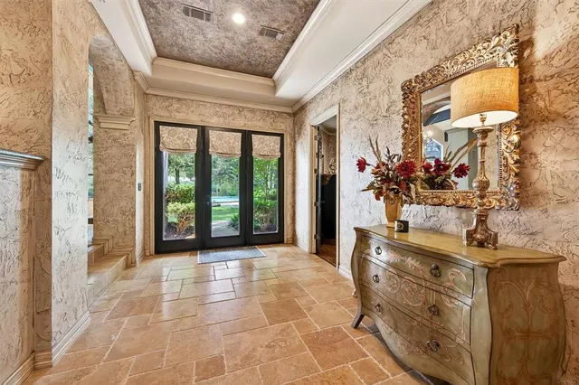 a view of a hallway with a dining table & chairs
