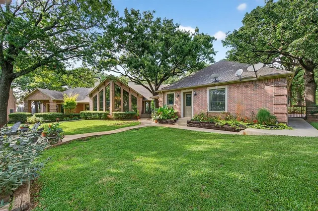 a front view of house with yard and green space
