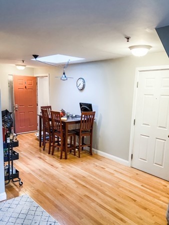 122 Tudor Street, Unit D Boston, MA 02127 - Photo 6 of 8 a view of a dining hall with furniture and wooden floor