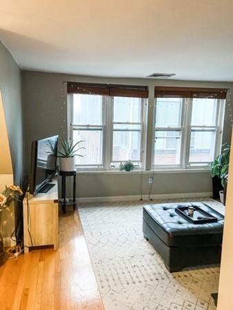 122 Tudor Street, Unit D Boston, MA 02127 - Photo 7 of 8 a living room with a rug and a table