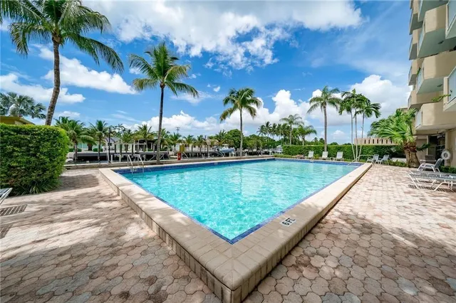 a view of swimming pool with a table and chairs