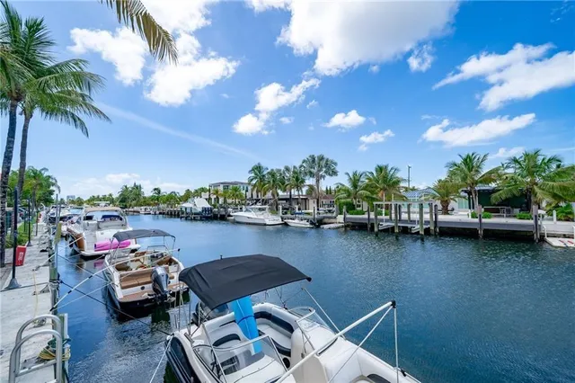 a front view of a house with lake view and a garden