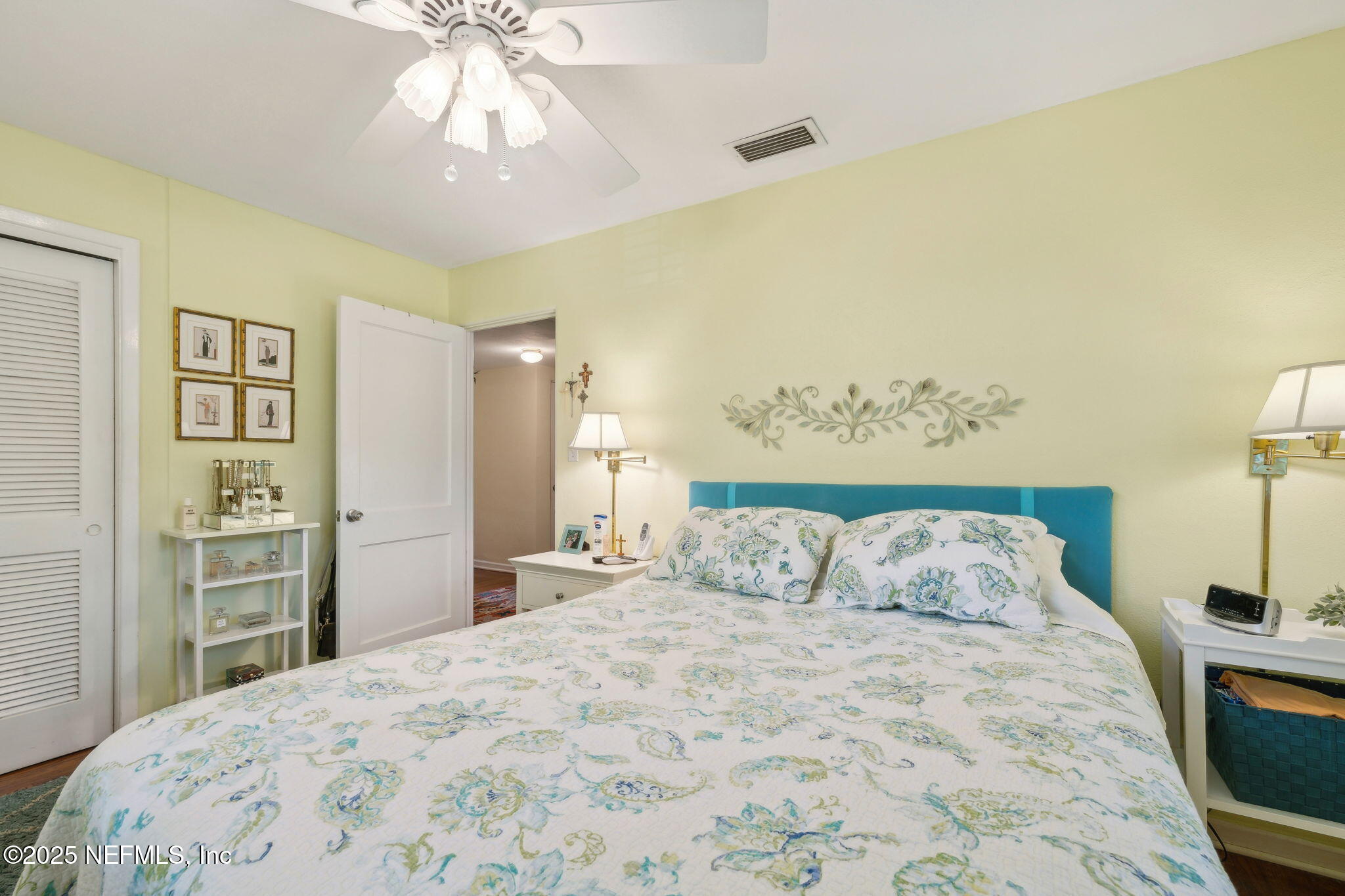 4504 Milstead Road Jacksonville, FL 32210 - Photo 17 of 33 a bedroom with a bed and a chandelier