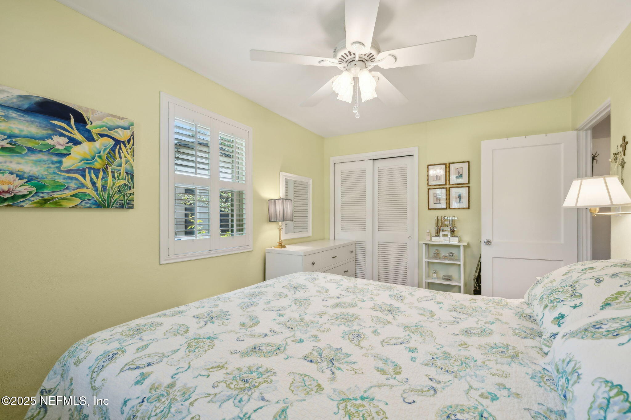 4504 Milstead Road Jacksonville, FL 32210 - Photo 18 of 33 a bedroom with a bed and a chandelier