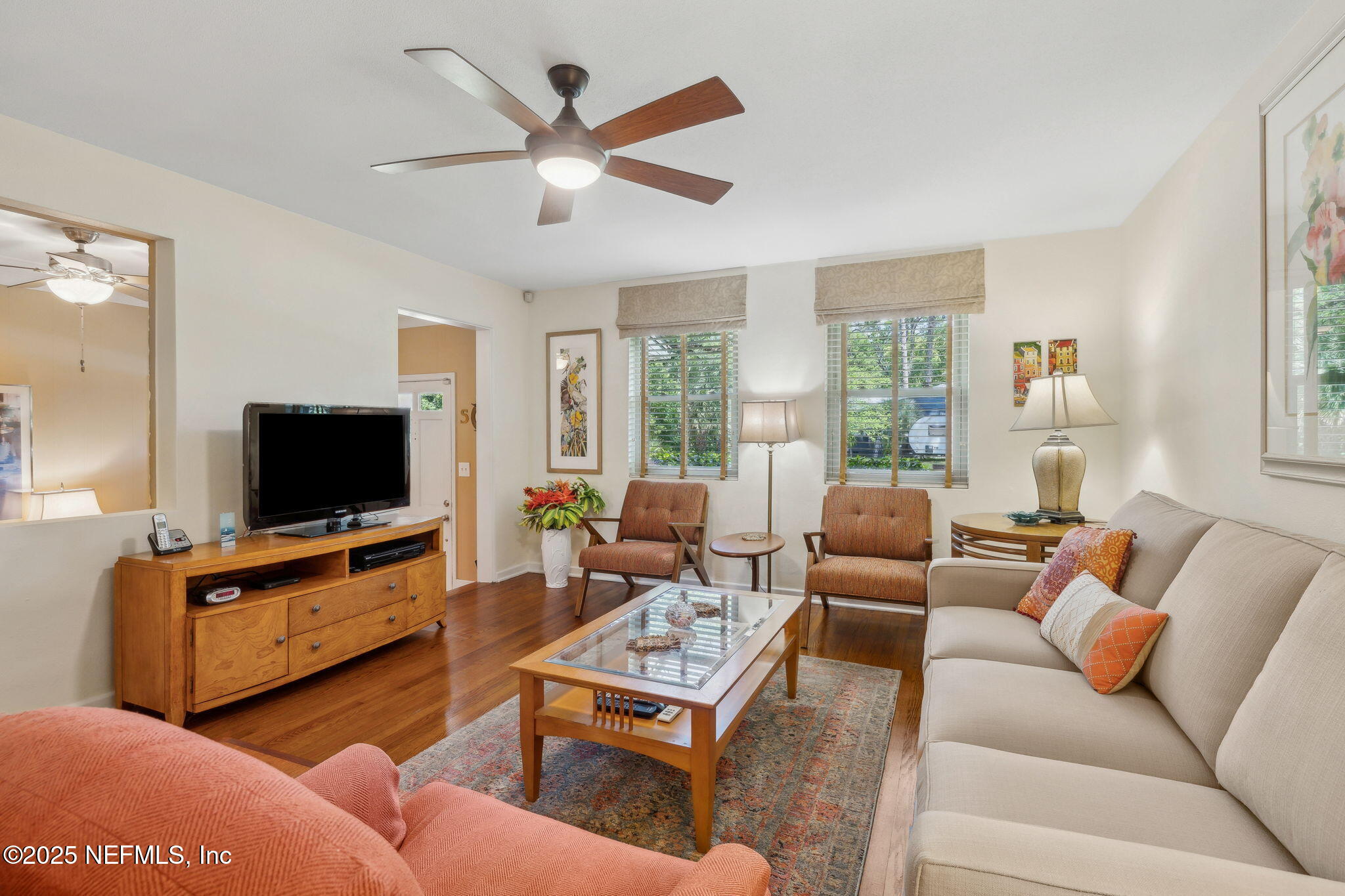 4504 Milstead Road Jacksonville, FL 32210 - Photo 8 of 33 a living room with furniture a flat screen tv and a large window
