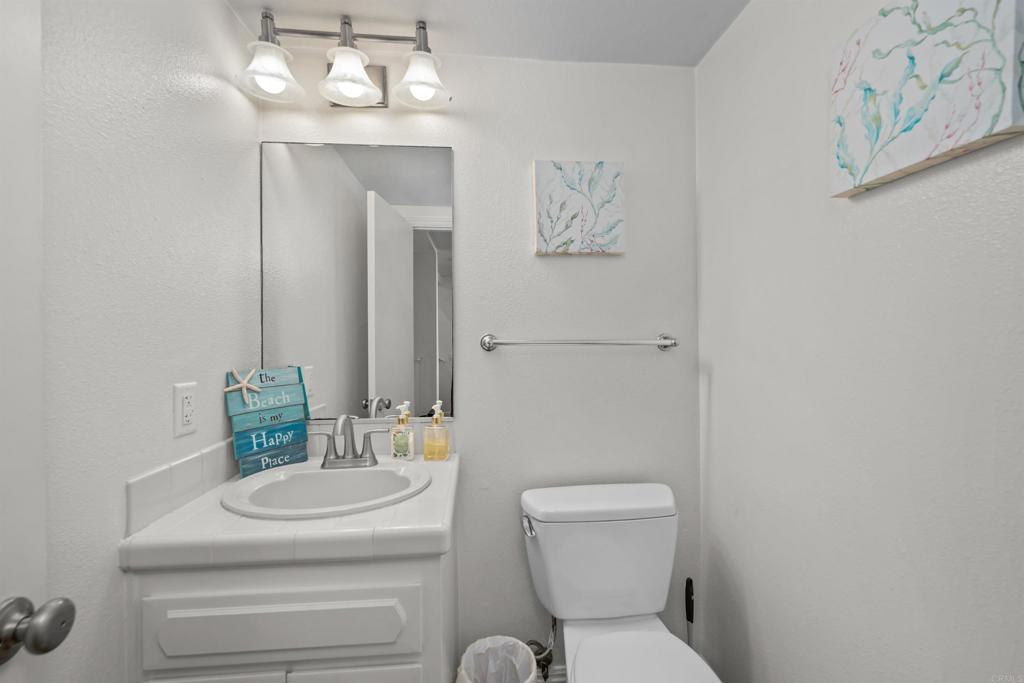 368 Hemlock Avenue Carlsbad, CA 92008 - Photo 15 of 32 a bathroom with a toilet sink and mirror