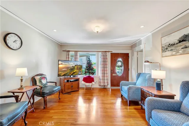 a living room with furniture a rug and a large window