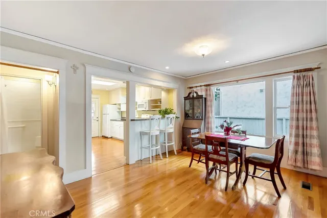 a dining room with furniture window and wooden floor