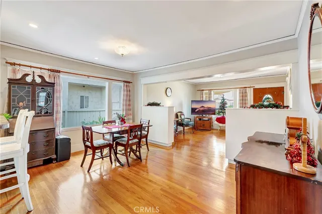 a dining room with furniture and wooden floor