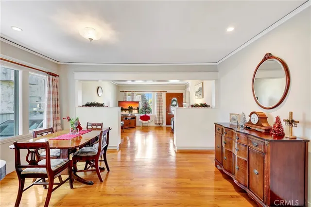 a dining room with furniture and wooden floor