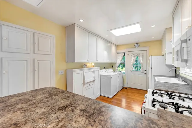 a room with a bed and a view of kitchen