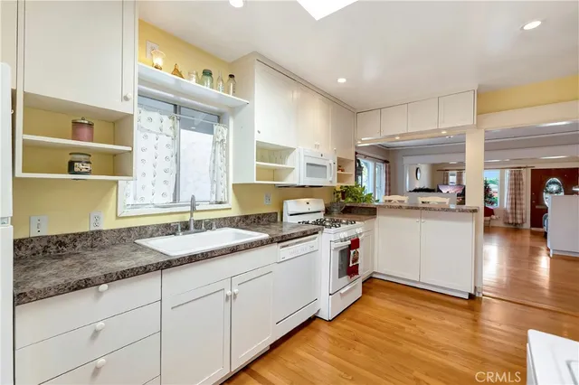 a kitchen with granite countertop a sink and cabinets