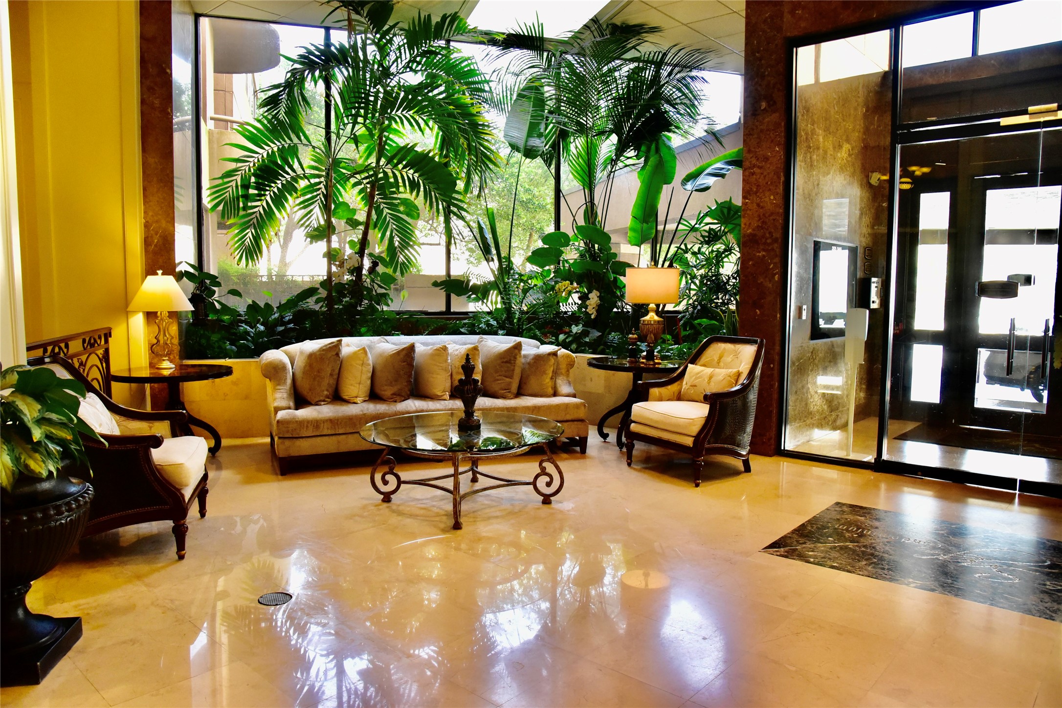3525 Sage Road, Unit 701 Houston, TX 77056 - Photo 36 of 48 Luxurious, well-lit lobby featuring comfortable seating area, indoor plants, and a welcoming ambiance to the property.