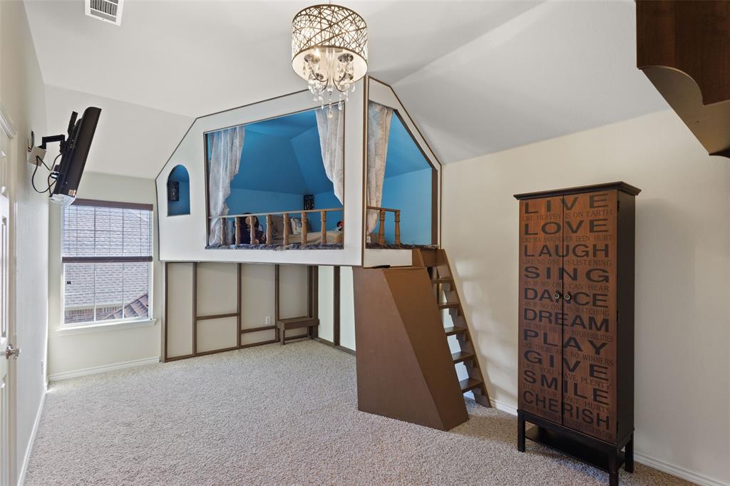 10414 Broadmoor Lane Rowlett, TX 75089 - Photo 23 of 38 Bedroom featuring light colored carpet, vaulted ceiling, and suspended lighting