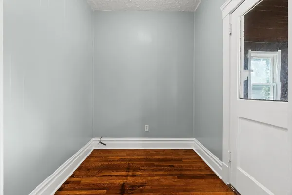 a view of a room with wooden floor and small space