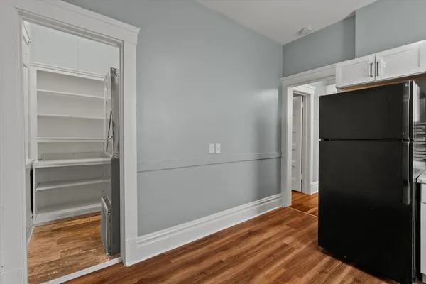 a view of empty room with wooden floor