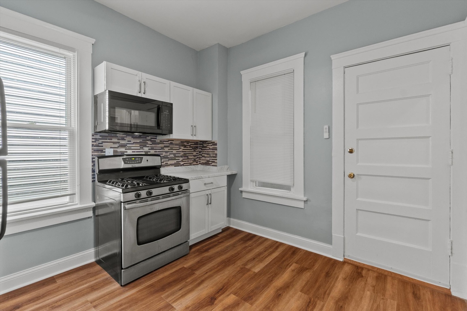 820 East 89th Place, Unit 2 Chicago, IL 60619 - Photo 6 of 15 a kitchen with a stove and a microwave