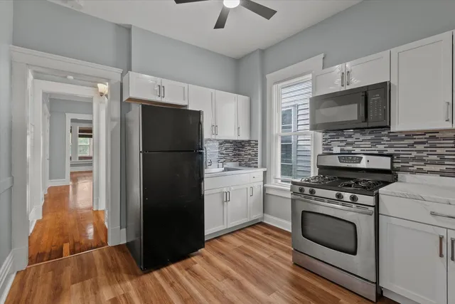 a kitchen with a refrigerator stove and microwave