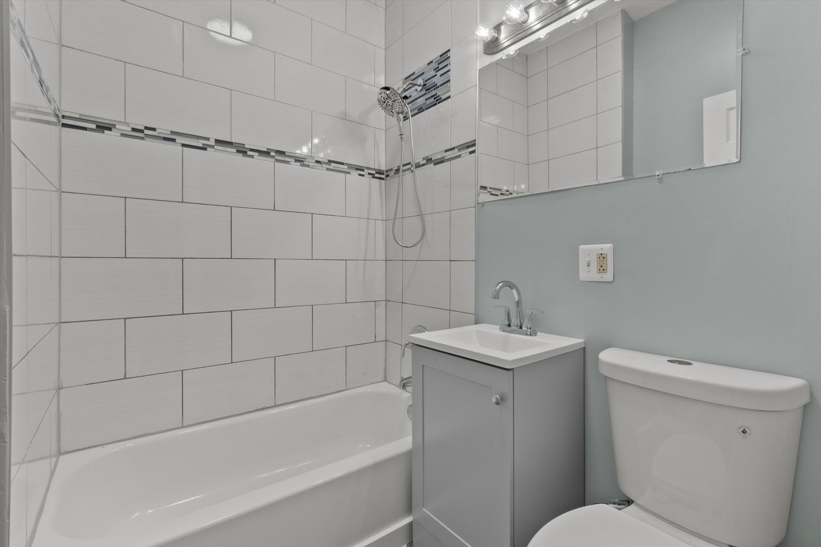 820 East 89th Place, Unit 2 Chicago, IL 60619 - Photo 8 of 15 a bathroom with a sink a toilet and shower