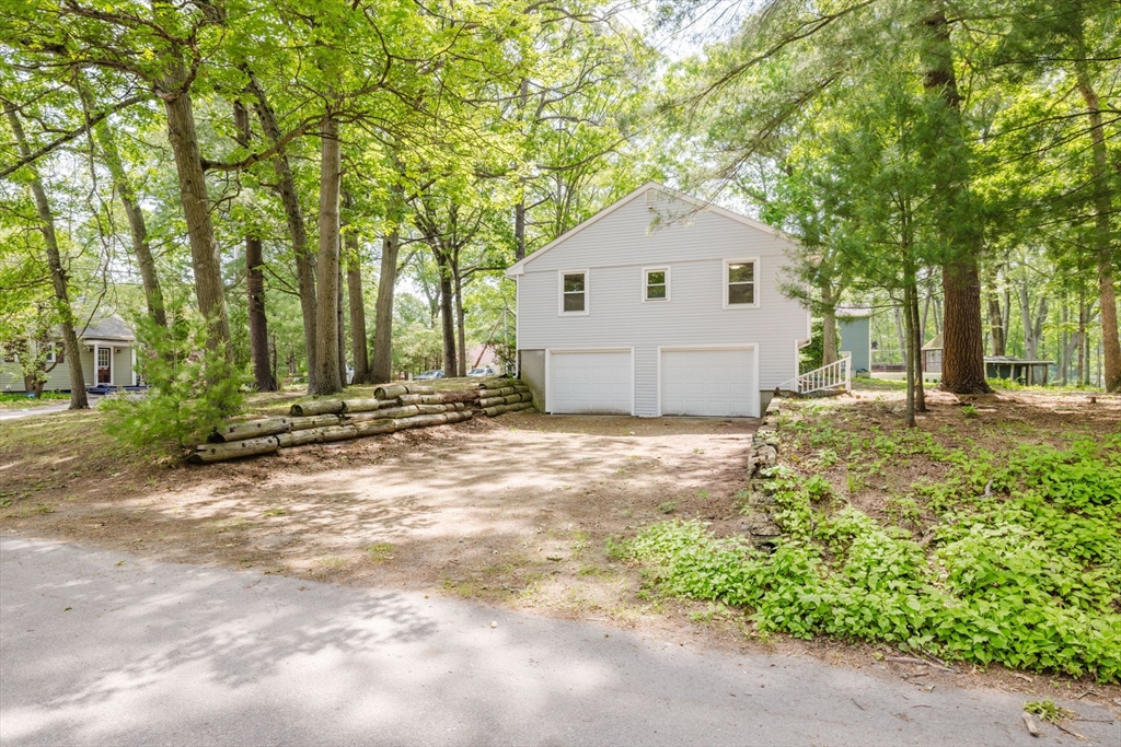 24 Sagamore Road Attleboro, MA 02703 - Photo 11 of 39 a view of a white house in front of a yard with large trees