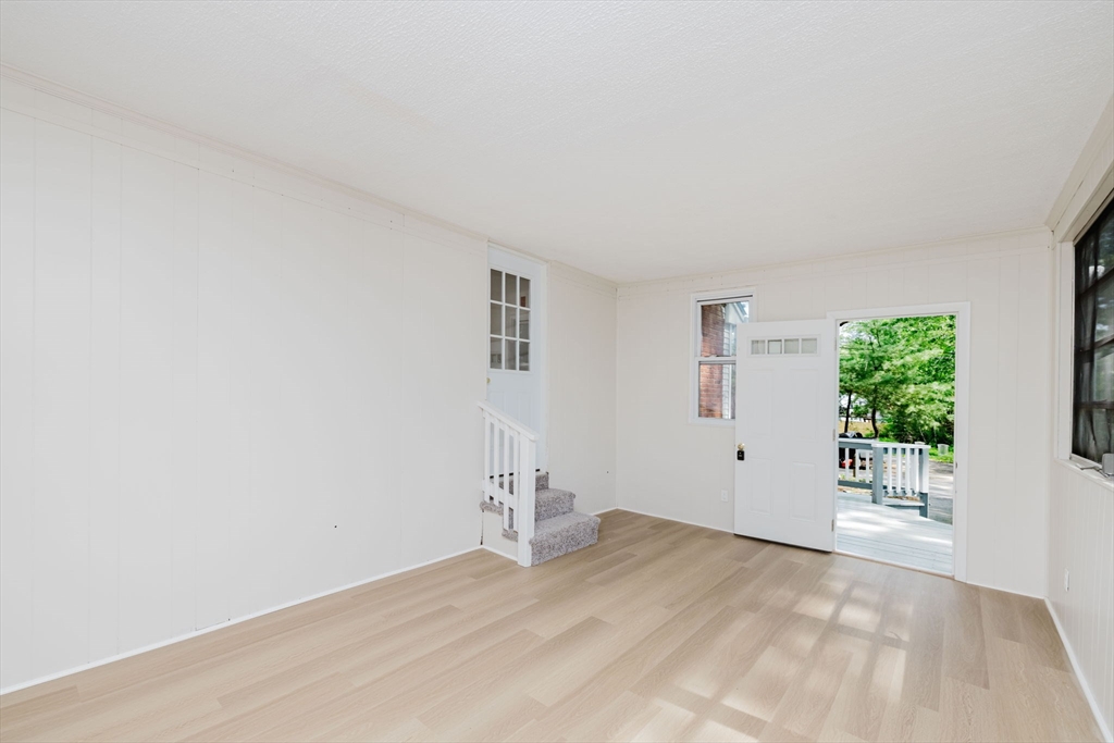 24 Sagamore Road Attleboro, MA 02703 - Photo 12 of 39 a view of empty room with wooden floor and fan