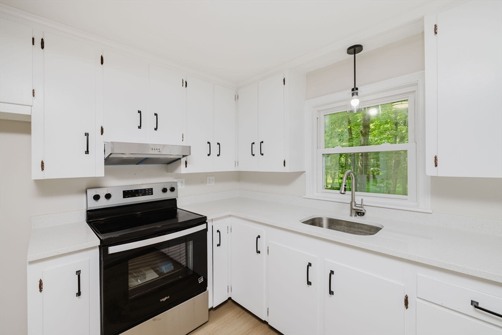 24 Sagamore Road Attleboro, MA 02703 - Photo 15 of 39 a kitchen with stainless steel appliances white cabinets and a sink