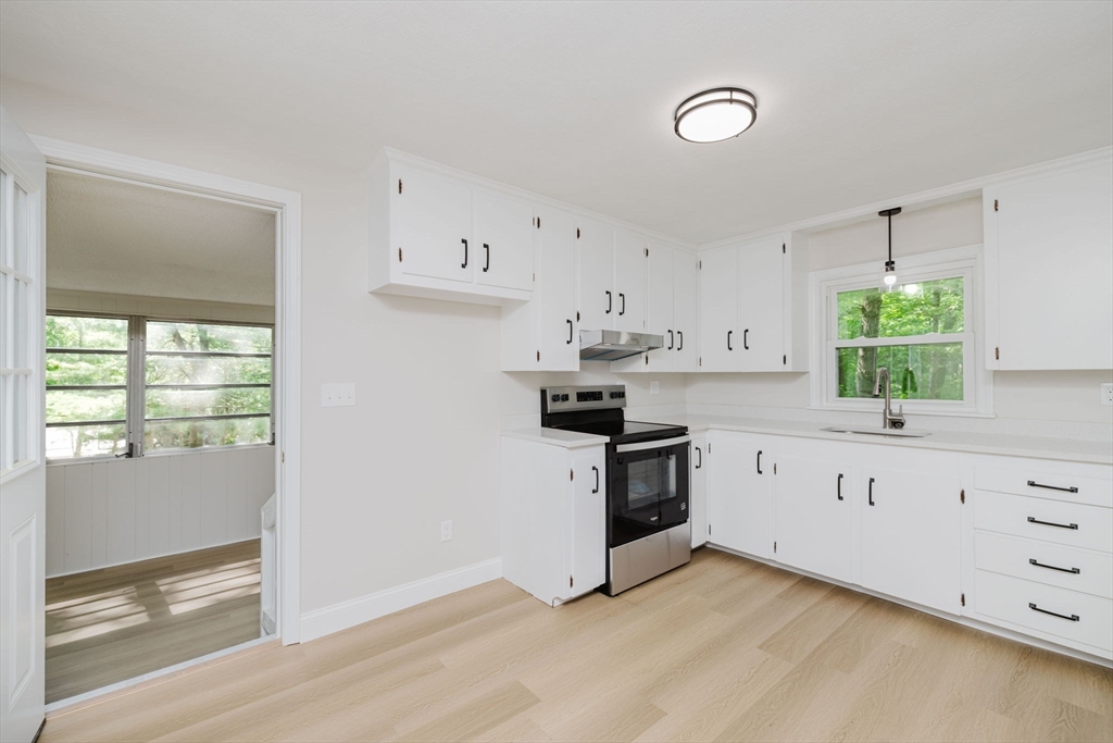 24 Sagamore Road Attleboro, MA 02703 - Photo 16 of 39 a kitchen with granite countertop white cabinets and white appliances