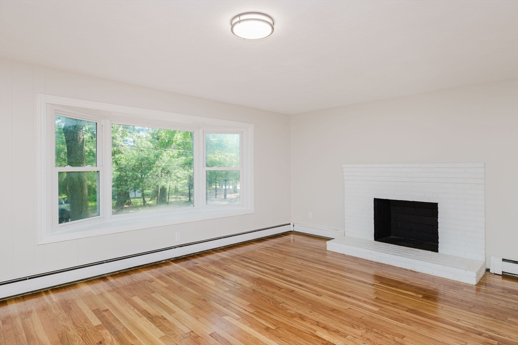 24 Sagamore Road Attleboro, MA 02703 - Photo 20 of 39 a view of an empty room with wooden floor and a window