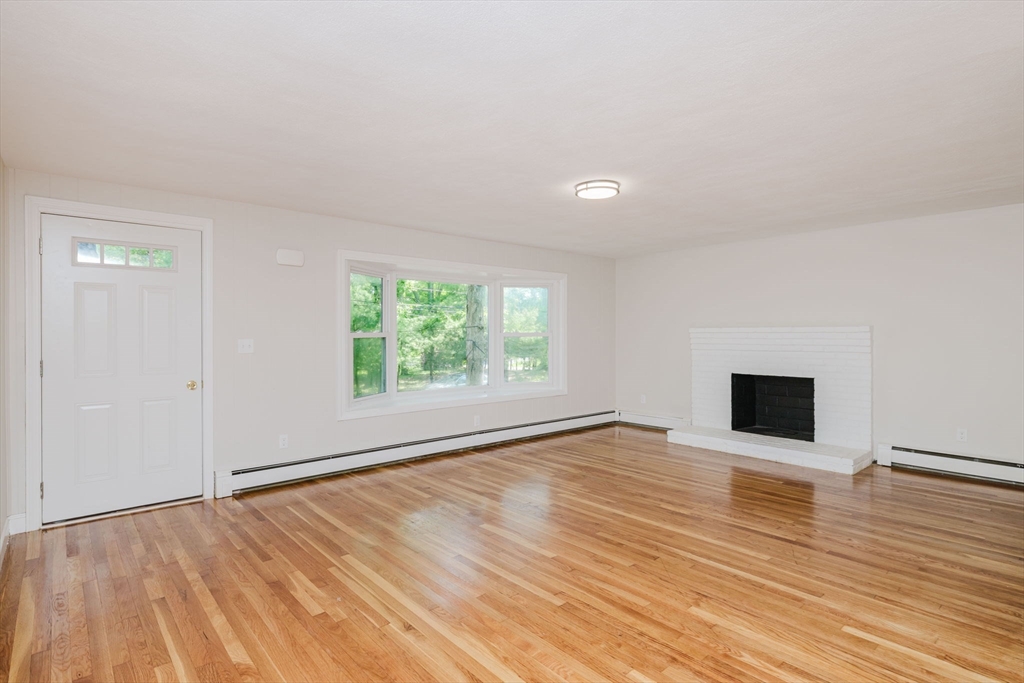 24 Sagamore Road Attleboro, MA 02703 - Photo 22 of 39 a view of an empty room with wooden floor and a window