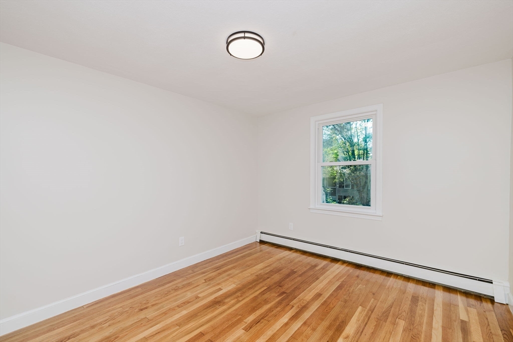 24 Sagamore Road Attleboro, MA 02703 - Photo 29 of 39 a view of an empty room with wooden floor and a window