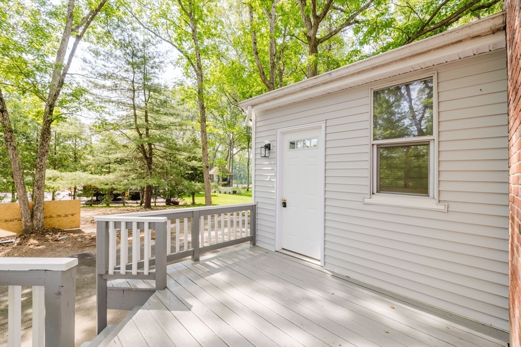 24 Sagamore Road Attleboro, MA 02703 - Photo 5 of 39 a view of a white house with a large window and wooden fence