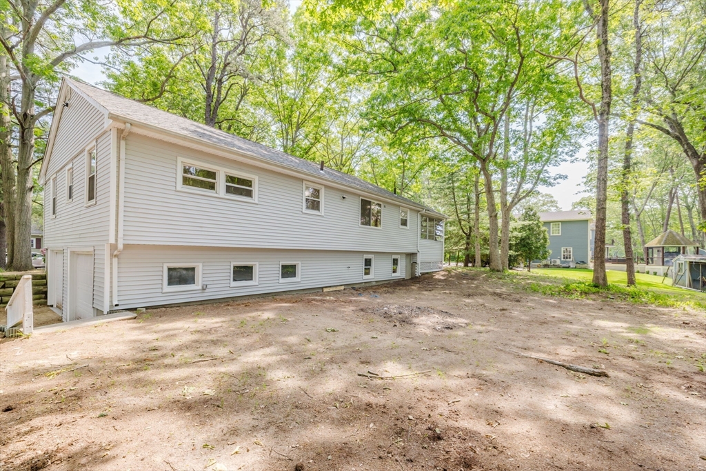 24 Sagamore Road Attleboro, MA 02703 - Photo 6 of 39 a backyard of a house with large trees and plants