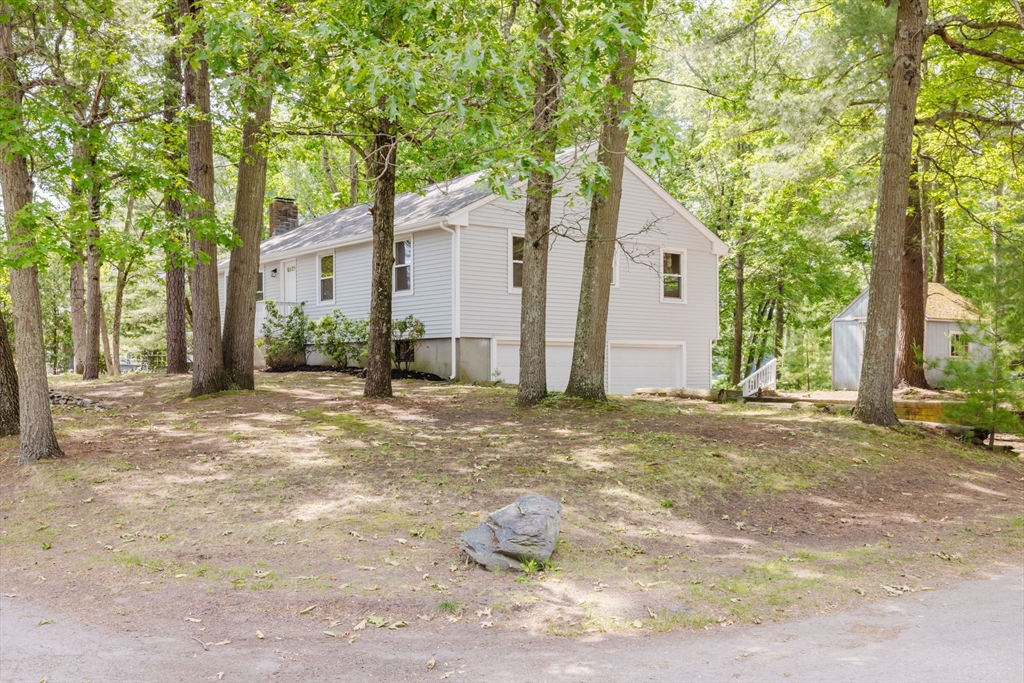 24 Sagamore Road Attleboro, MA 02703 - Photo 10 of 39 a backyard of a house with large trees and outdoor seating