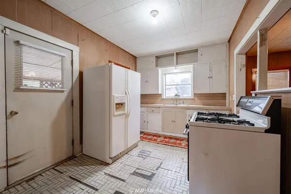 a kitchen with a stove a refrigerator and a stove