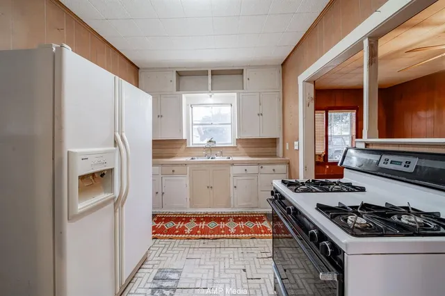 a kitchen with a stove and a refrigerator