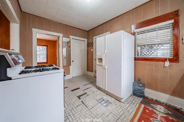 a room with a refrigerator and a window