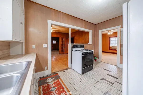 a kitchen with stainless steel appliances a stove a sink and a refrigerator