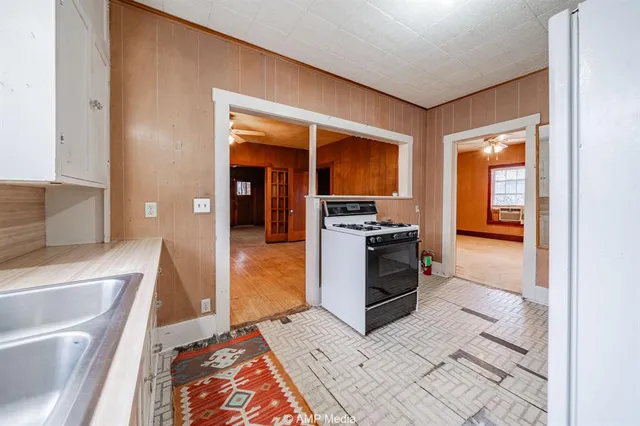 a kitchen with stainless steel appliances a stove a sink and a refrigerator