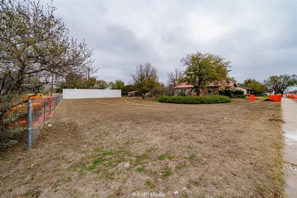 1104 North Avenue Avenue East Haskell, TX 79521 - Photo 21 of 30 a view of a yard with potted plants and big trees