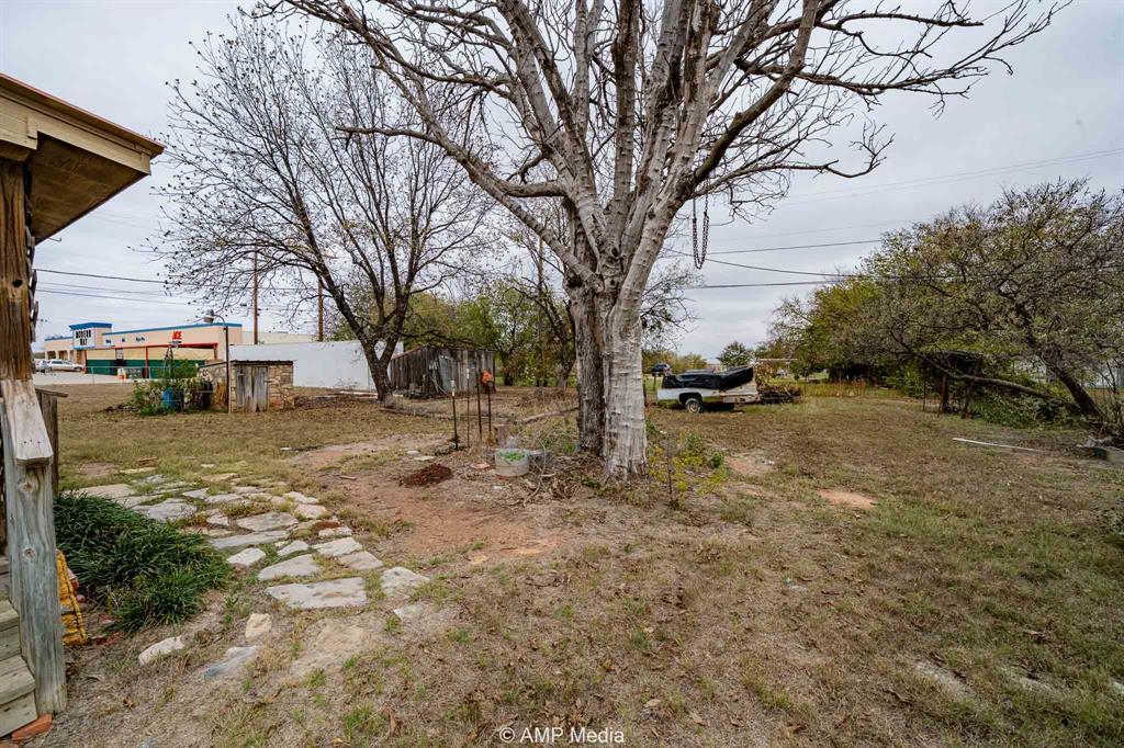 1104 North Avenue Avenue East Haskell, TX 79521 - Photo 23 of 31 a view of a yard with trees