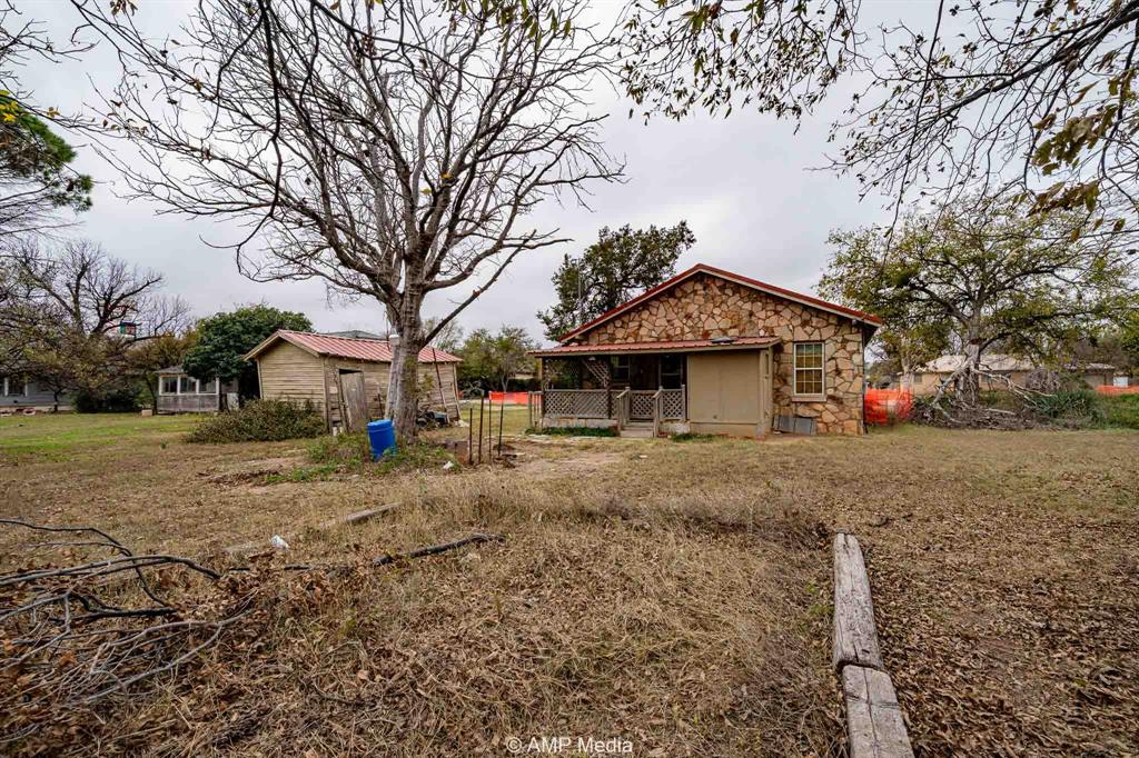 1104 North Avenue Avenue East Haskell, TX 79521 - Photo 3 of 30 a front view of a house with a yard and garage
