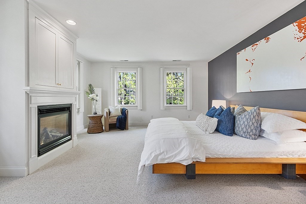 257 Nashoba Road Concord, MA 01742 - Photo 20 of 41 a bed room with a bed and a fireplace