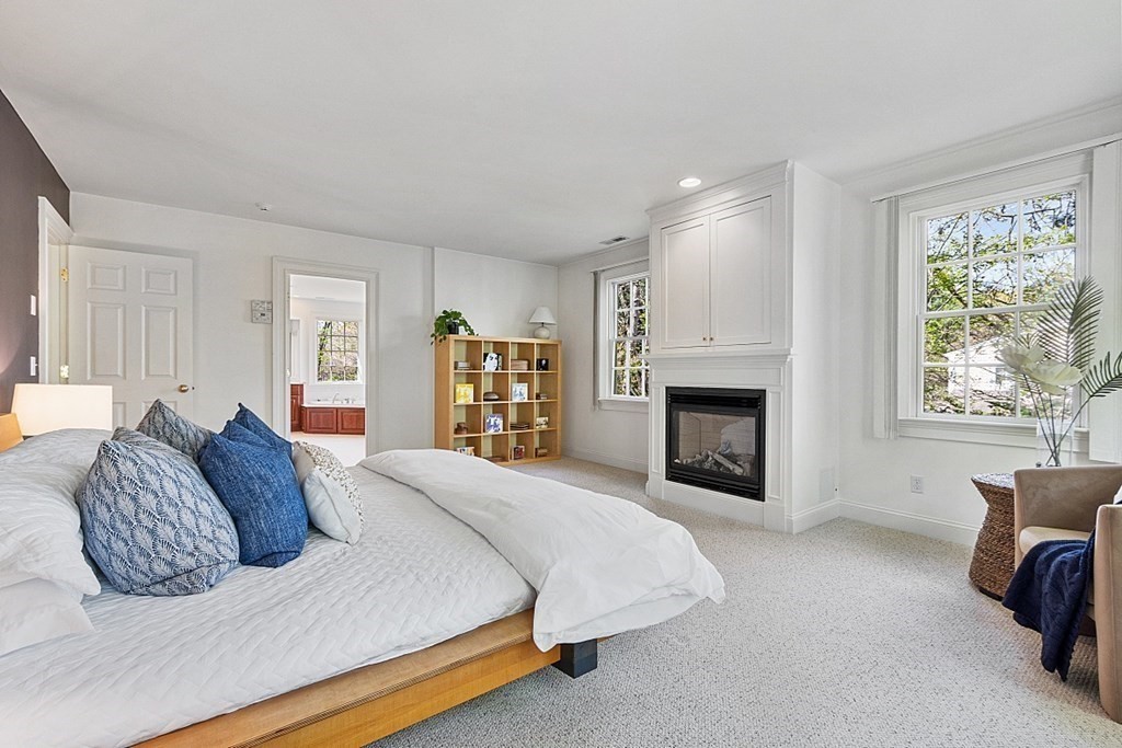 257 Nashoba Road Concord, MA 01742 - Photo 22 of 41 a bedroom with a bed and a fireplace