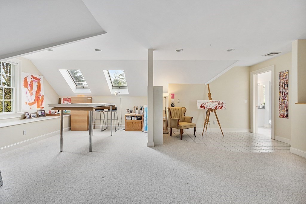 257 Nashoba Road Concord, MA 01742 - Photo 28 of 41 a view of a livingroom with furniture and a flat screen tv