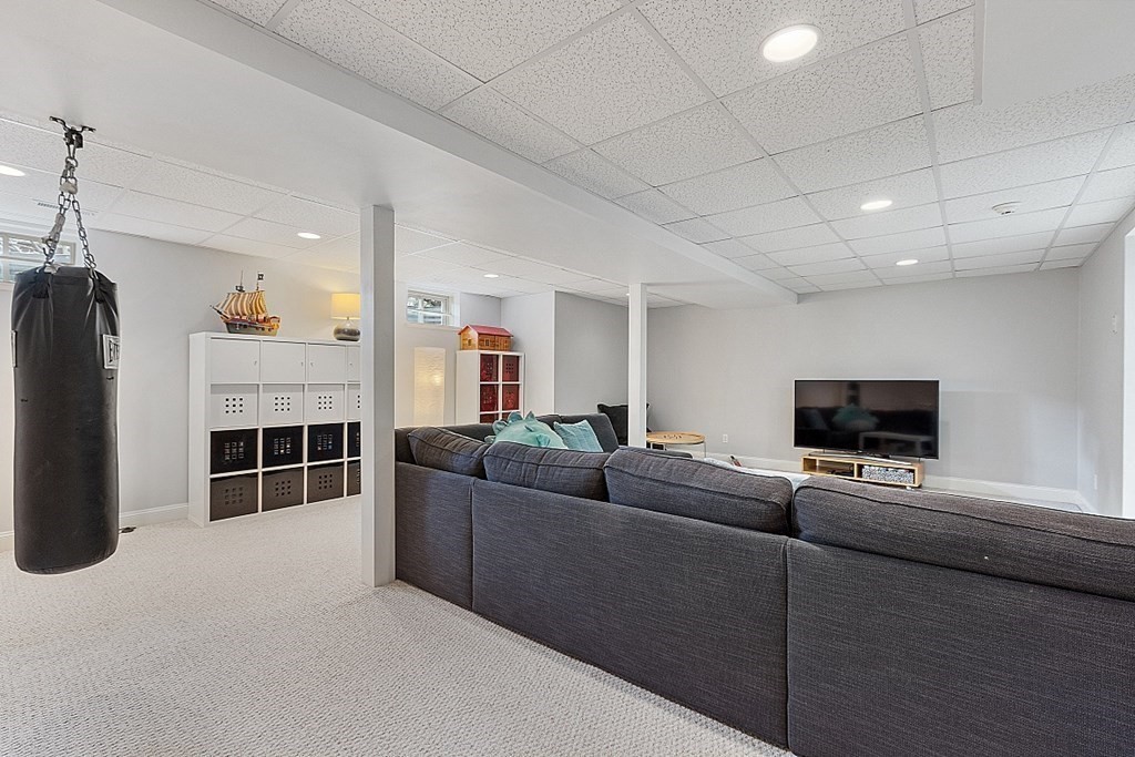 257 Nashoba Road Concord, MA 01742 - Photo 34 of 41 a living room with furniture a flat screen tv and a fireplace