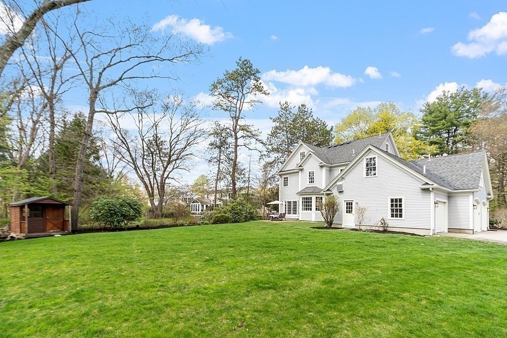 257 Nashoba Road Concord, MA 01742 - Photo 38 of 41 a view of a white house with a big yard and large trees
